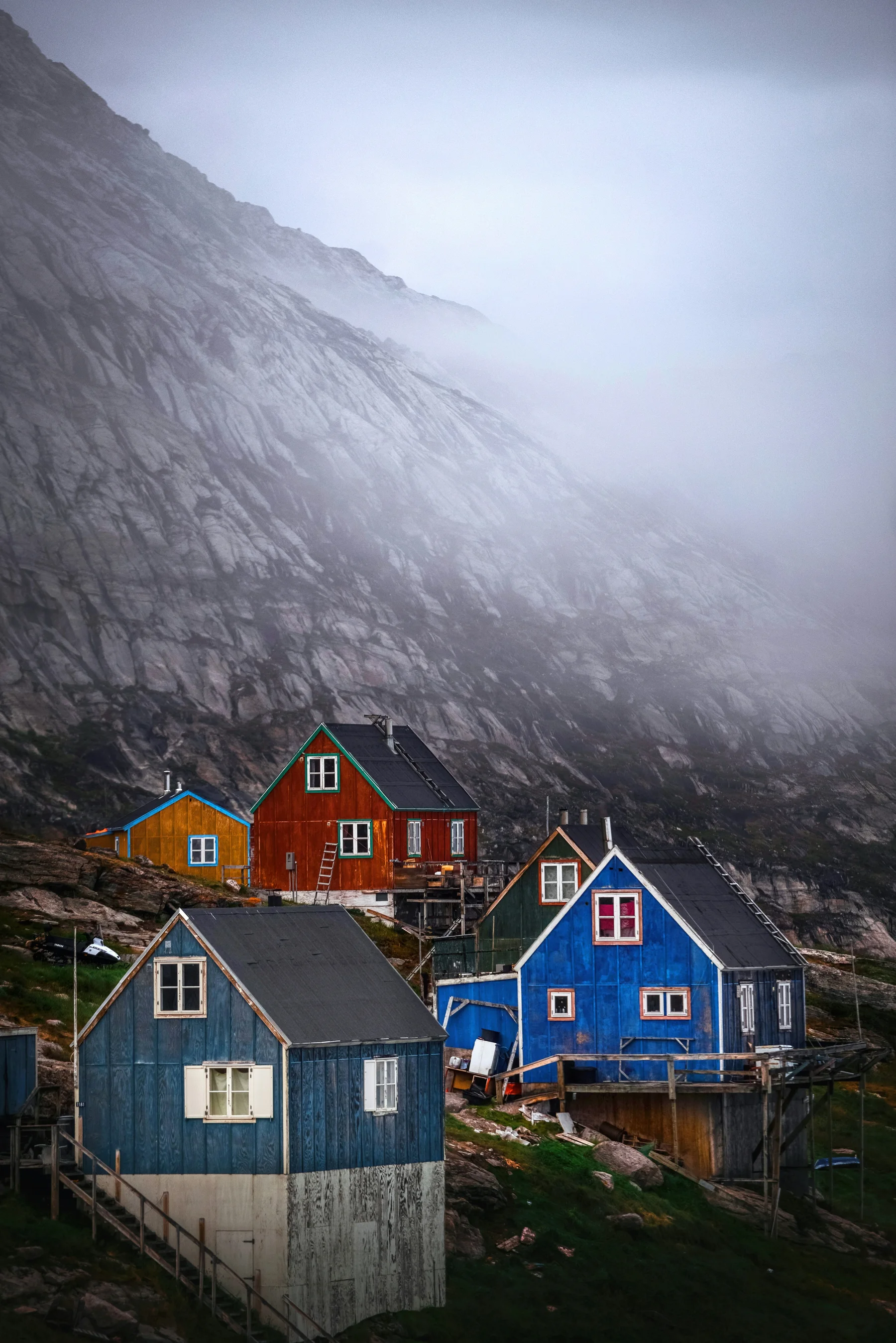 Colorful coastal homes beneath a mountain in Greenland